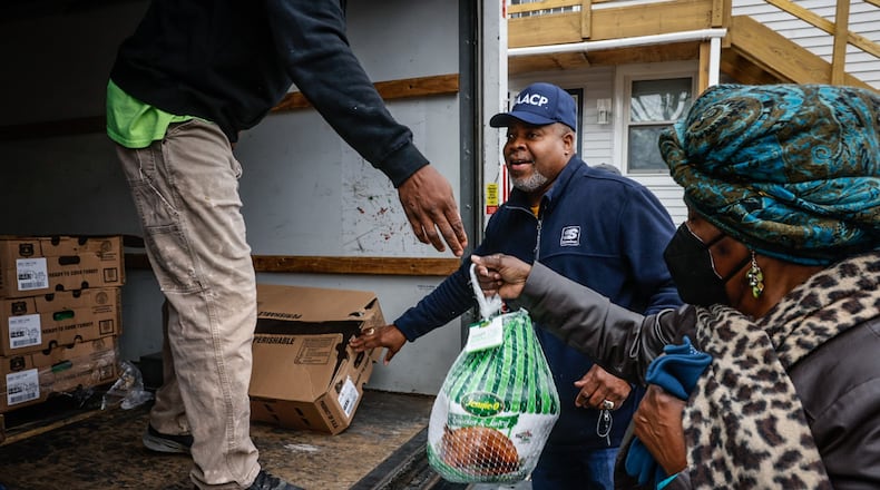 The Dayton Unit of the NAACP on Salem Ave. gave away 200 turkeys Friday November 18, 2022. It was the third annual giveaway for the greater Dayton area. President of the Dayton Unit of the NAACP, Dr. Derrick L. Foward is in the background. JIM NOELKER/STAFF