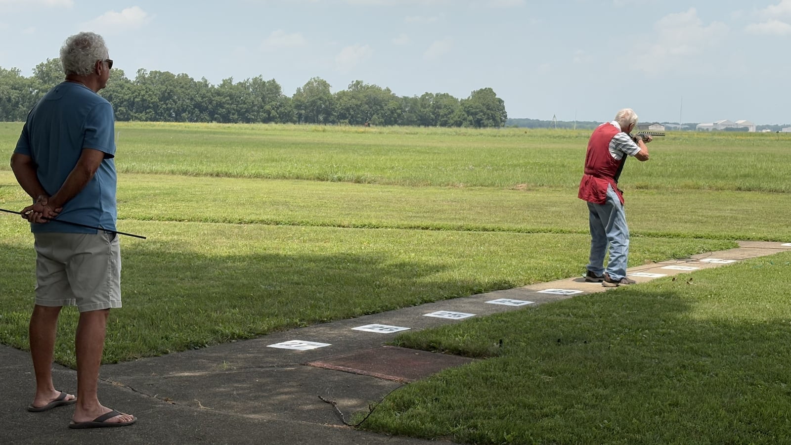 Terry Dixon watches his dad, Benny Dixon, competing Tuesday at the Retirees Shoot at the Base Rod & Gun Club. TOM ARCHDEACON/CONTRIBUTED PHOTO