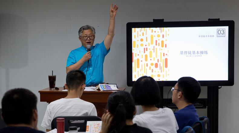 FILE - Pastor Ezra Jin Mingri leads a class on the basics of Christian beliefs at Zion Church in Beijing, Aug. 4, 2018. (AP Photo/Ng Han Guan, File)