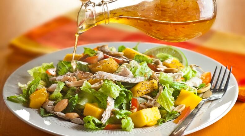 A dressing of rice vinegar, fish sauce, sesame oil, honey, ginger and garlic ties together a tropical salad of fresh mango and cubed chicken (Bill Hogan/Chicago Tribune/TNS)