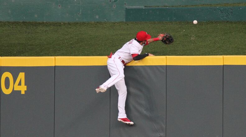 Reds center fielder Billy Hamilton can’t get to a home run hit by the Brewers’ Manny Pina on Monday, April 30, 2018, at Great American Ball Park in Cincinnati. David Jablonski/Staff