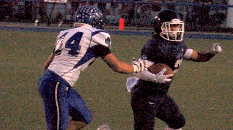 Collin Genslinger tries to outrun Brookville’s Alex Cherry to the corner during Valley View’s 49-28 win Friday night at Barker Field. John Cummings/CONTRIBUTED