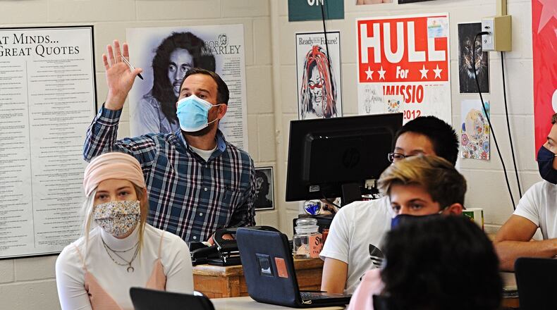A Beavercreek High School teacher works with students on Oct. 8, 2020.