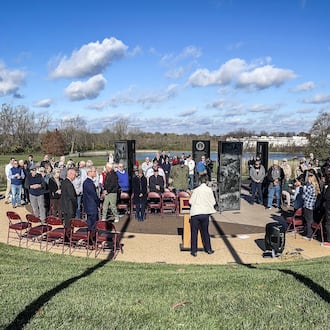 A group gathered at Veterans Plaza in Delco Park, Kettering to honor the nation's veteran on Veterans Day Nov. 11, 2024. JIM NOELKER/STAFF