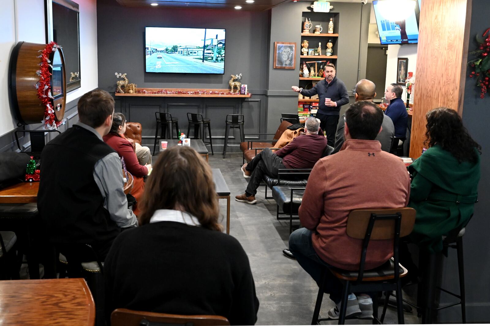 Butler County Finance Authority President and CEO Joshua Smith talks about the revitalization efforts in Hamilton during his tenure as city manager. Middletown leaders are considering a project that would demolish the Manchester Inn and construct a new mixed-use development that would include 100 to 125 apartments and 10,000 to 15,000 square feet of retail space. The meeting was held on Dec. 8, 2025, at the Pour House, which is at the Marcum in Hamilton, a CMC Properties building. MICHAEL D. PITMAN/STAFF