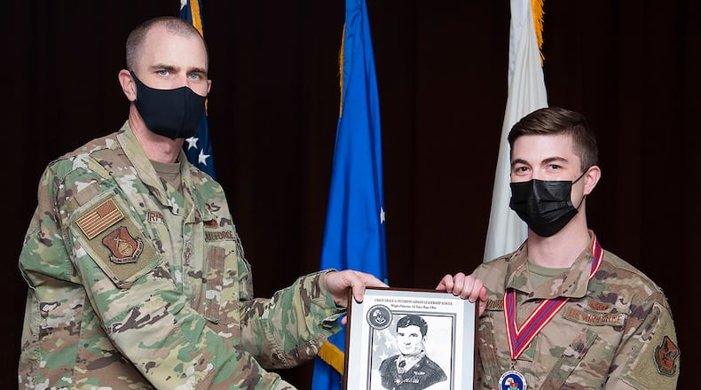 Chief Master Sgt. Christopher Murphy, National Air and Space Intelligence Center, presents the John L. Levitow Award to Senior Airman Zane Crawford during the Airman Leadership School graduation May 6 at the Wright-Patterson Club. The Levitow award is presented to the graduate demonstrating the highest degree of excellence as a leader and scholar. U.S. AIR FORCE PHOTO/R.J. ORIEZ