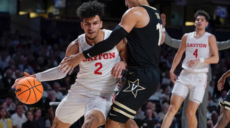 Dayton's Toumani Camara (2) drives against Vanderbilt's Myles Stute (10) in the first half of an NCAA college basketball game in the second round of the NIT Sunday, March 20, 2022, in Nashville, Tenn. (AP Photo/Mark Humphrey)