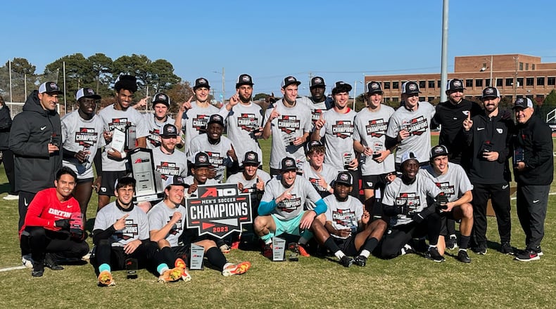 The Dayton men's soccer team poses with the A-10 tournament championship trophy on Sunday, Nov. 12, 2023, in Richmond, Va. Photo courtesy of UD