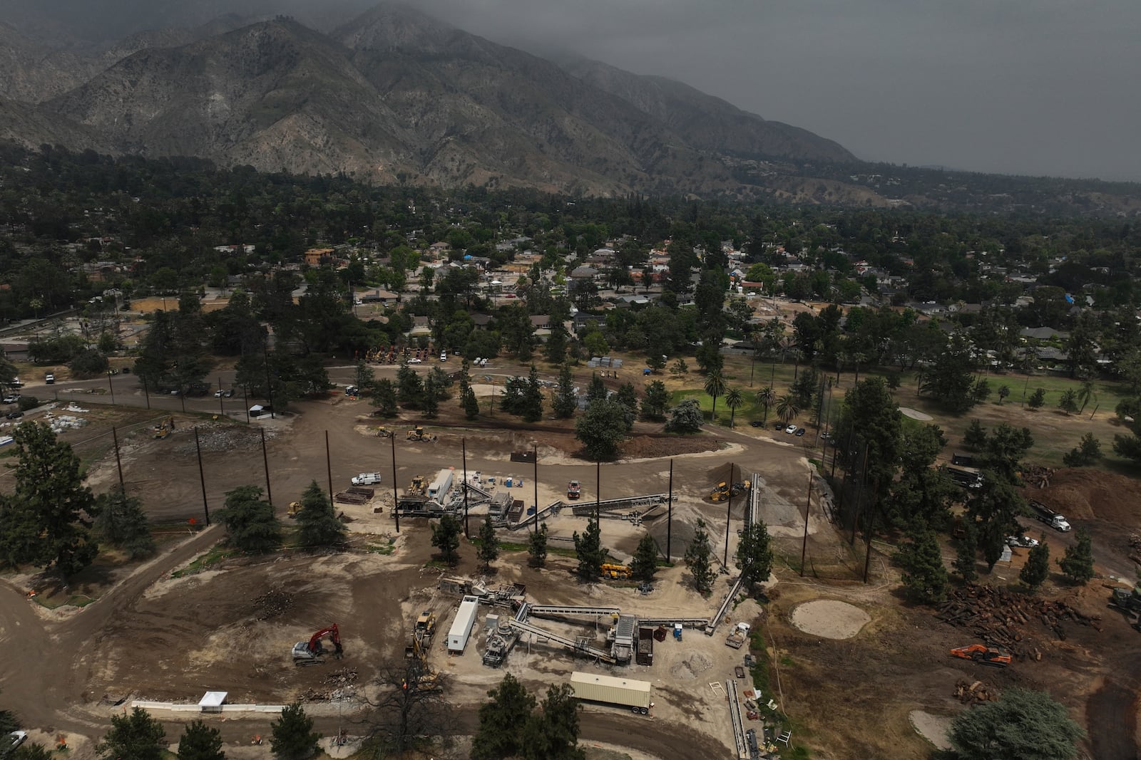 A recycling facility occupies a golf course in Altadena, Calif., Wednesday, June 4, 2025, where debris from wildfires is processed. (AP Photo/Jae C. Hong)