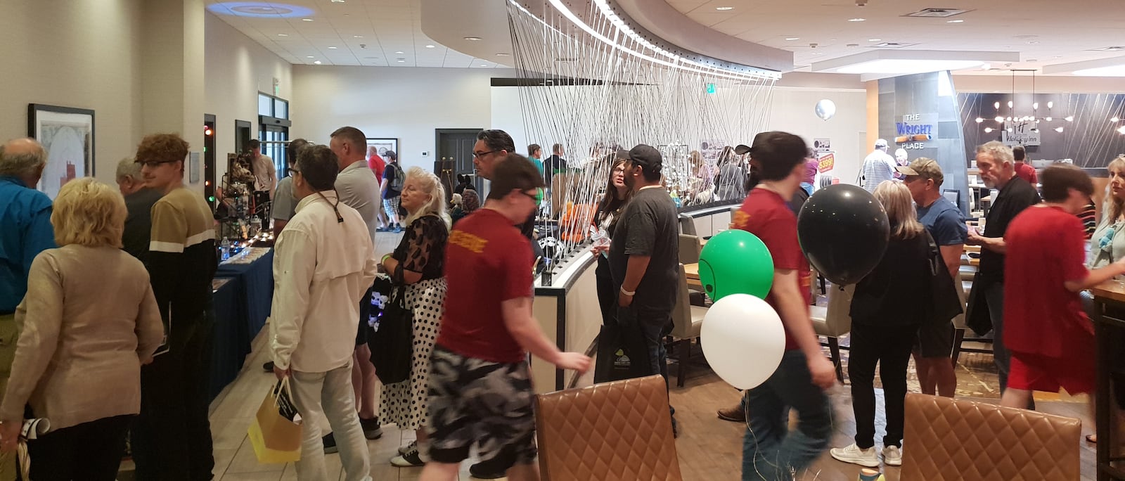 A longline forms as UFO-enthusiasts eagerly wait for an opportunity to take photos with Donald Schmitt following his keynote address at the UFO Conference in Fairborn.