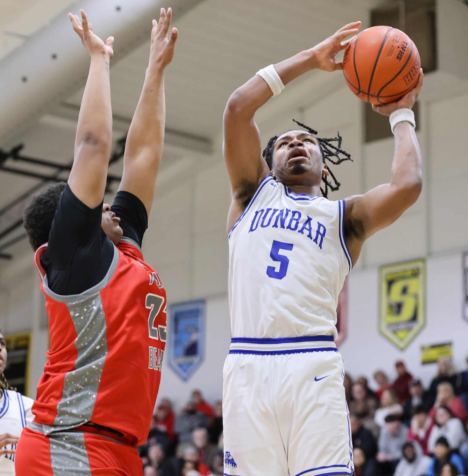 Dunbar sophomore guard Jay'Mal Whitfield shoots with pressure from Northridge's Eddie Conners during a Division IV district semifinal on Tuesday, March 3 at Sidney High School. BRYANT BILLING / STAFF
