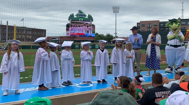 Gov. Mike DeWine and Ohio First Lady Fran DeWine celebrate local children graduating from Dolly Parton's Imagination Library of Ohio during the Dayton Dragons game on Sunday, Aug. 14, 2022. Dolly Parton's Imagination Library of Ohio provides books monthly to children under the age of five, at no cost to families. CONTRIBUTED\DOLLY PARTON'S IMAGINATION LIBRARY OF OHIO