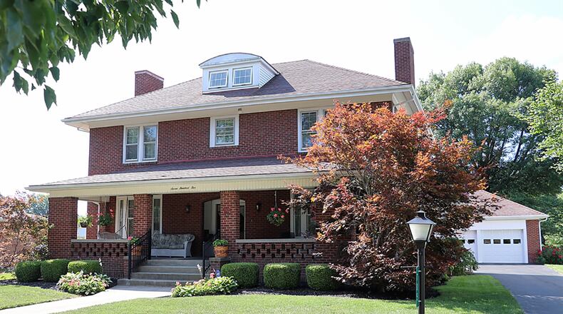 The brick 2-story, built in 1921, has about 2,850 sq. ft. of living space. A covered front porch offers cool outdoor entertainment space while the back yard has quaint garden beds and a paver-brick patio with new rear neighbors. CONTRIBUTED PHOTO BY KATHY TYLER