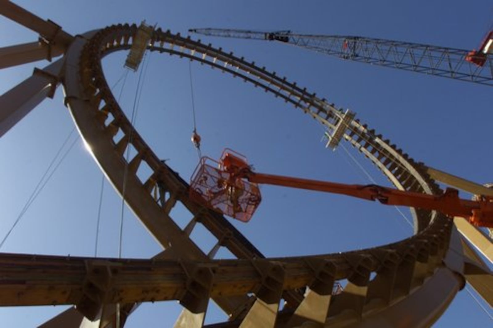 Track is being laid for the Son of Beast's loop at Kings Island. The giant wooden roller coaster was scheduled to open on April 14, 2000 along with the park, but officials had to hold a meeting to determine if the attraction would be completed in time. The loop has since been removed after passengers were injured in 2006.