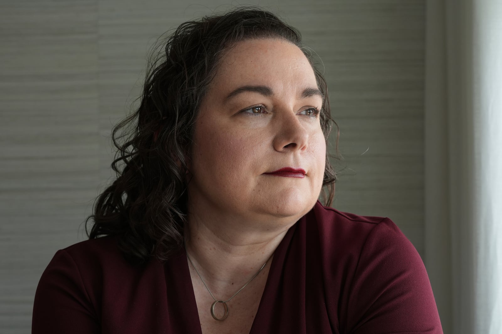 Brandy Ellis, who had electrodes installed in her brain and pacemaker-like device installed in her chest as part of an experimental treatment for depression, sits at her home Thursday, July 24, 2025, in Delray Beach, Fla. (AP Photo/Marta Lavandier)