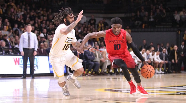 Dayton’s Jalen Crutcher dribbles against Virginia Commonwealth’s Jonathan Williams on Saturday, Feb. 10, 2018, at UD Arena. David Jablonski/Staff