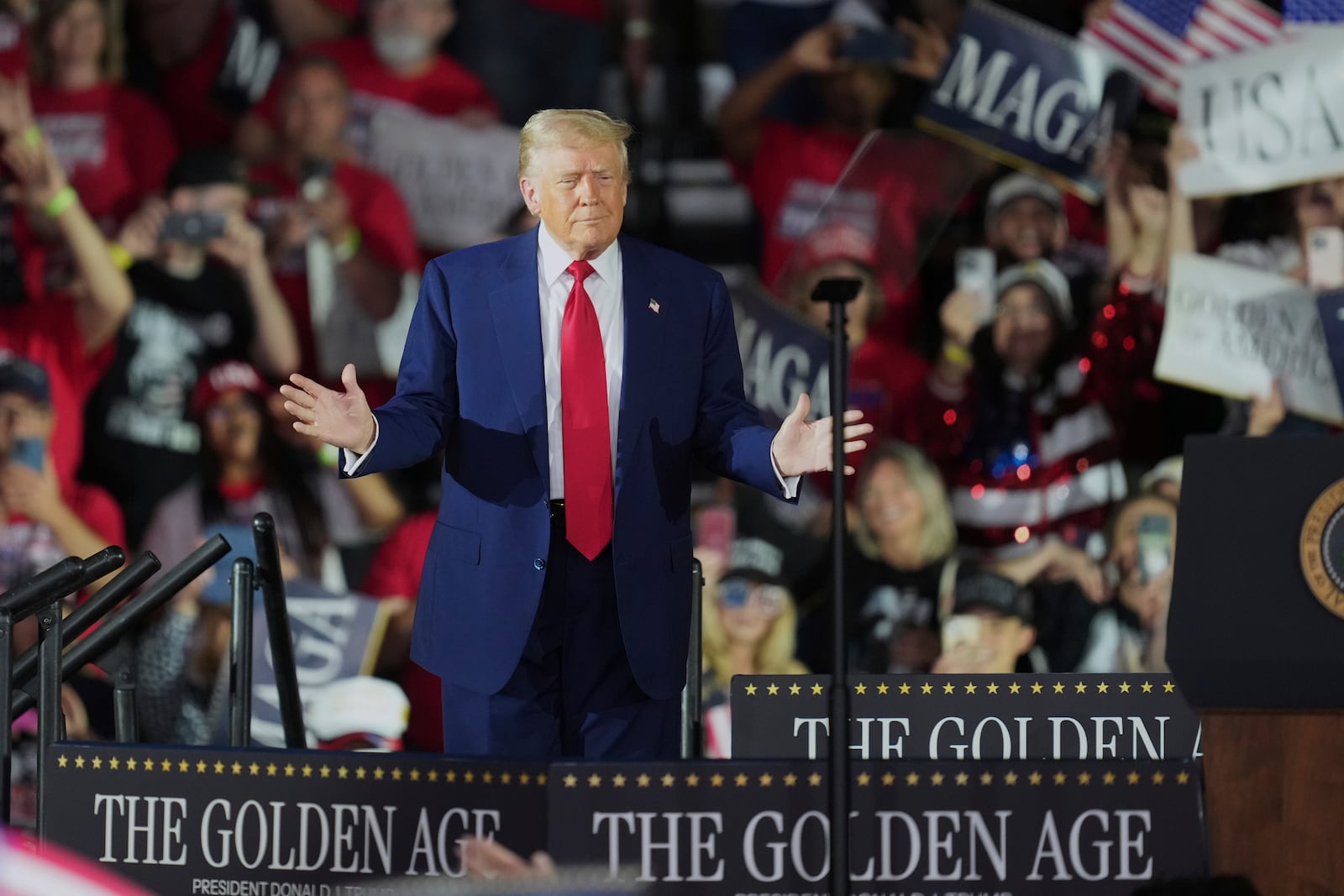 President Donald Trump arrives to speak on his first 100 days at Macomb County Community College Sports Expo Center, Tuesday, April 29, 2025, in Warren, Mich. (AP Photo/Paul Sancya)