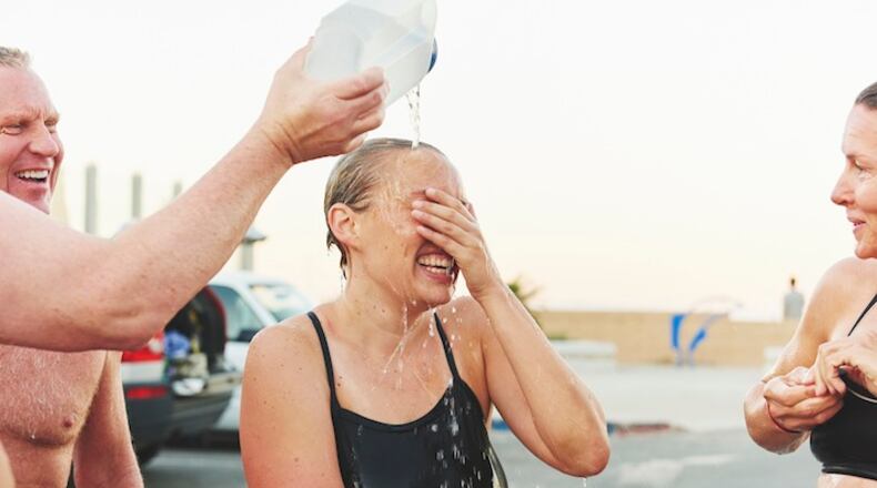 Water is poured on Karina Garcia’s head after a practice swim with the Deep Enders on the beach in Ventura, Calif., Oct. 10, 2015. Six members of the Deep Enders are making a 70-mile open-water relay attempt from from San Nicolas Island to the Palos Verdes peninsula on the California mainland that began Monday, Oct. 12. (Jake Michaels/The New York Times)