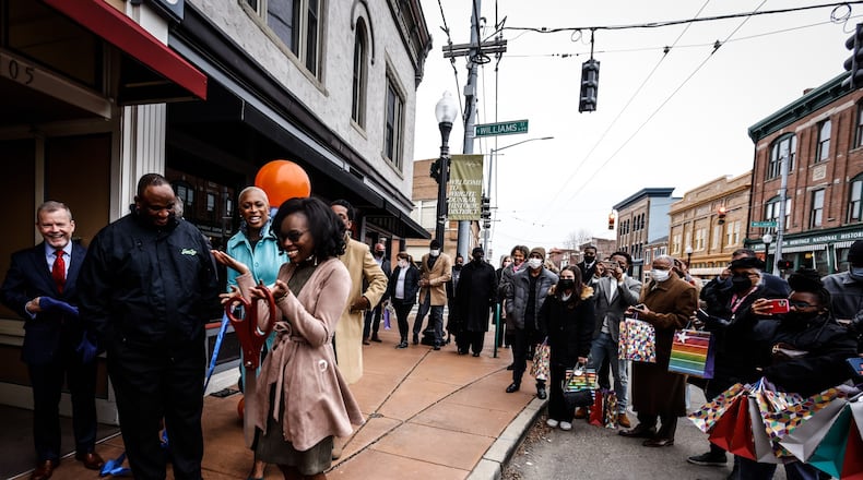 Whitney Barkley, Director of the Greater West Dayton Incubator, reacts to the ribbon cutting of the new Entrepreneur's Center on West Third St. in Dayton. JIM NOELKER/STAFF