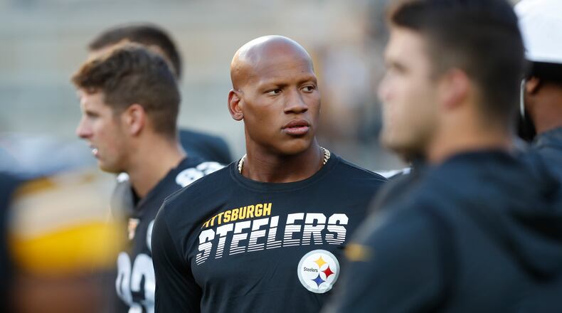 FILE - In this Aug. 9, 2019, file photo, Pittsburgh Steelers Ryan Shazier, center, watches warmups before an NFL preseason football game against the Tampa Bay Buccaneers in Pittsburgh. The Pittsburgh Steelers have placed the inside linebacker Ryan Shazier on the reserved/retired list. But the team says the move doesn't rule out the possibility of Shazier playing again. (AP Photo/Keith Srakocic, File)
