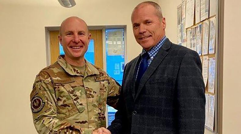 Lawrence “Larry’” Knight Sr., deputy commander of Air Force Installation Contracting Center’s 771st Enterprise Sourcing Squadron, shakes hands with Maj. Gen. Carl Schaefer, Air Force Materiel Command deputy commander. Knight was recognized by Schaefer Feb. 3 with an AFMC coin and honorable citation.