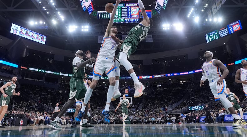 Milwaukee Bucks' Giannis Antetokounmpo dunks over Oklahoma City Thunder's Chet Holmgren during the second half of an NBA basketball game Wednesday, Jan. 21, 2026, in Milwaukee. (AP Photo/Morry Gash)
