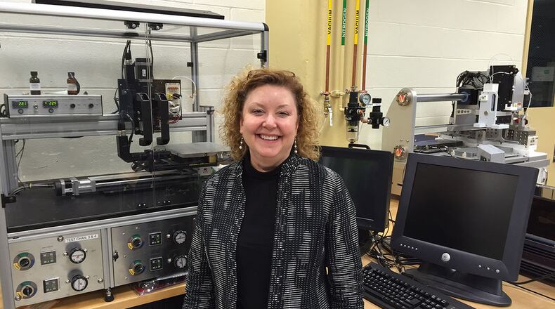 Dr. Katie Thorp, then chief of the Soft Matter Materials Branch, Materials and Manufacturing Directorate, Air Force Research Laboratory, stands in front of a printer that can use conductive, multi-purpose inks in this photo taken in March 2015. Thorp had fought cancer since 1994 and had trained as a resilience training assistant to pass along knowledge she had gained in her own personal battle with cancer. Thorp passed away in July 2018, just one day after learning about winning the Society of Women Engineers PRISM Award. (Skywrighter photo/Amy Rollins)