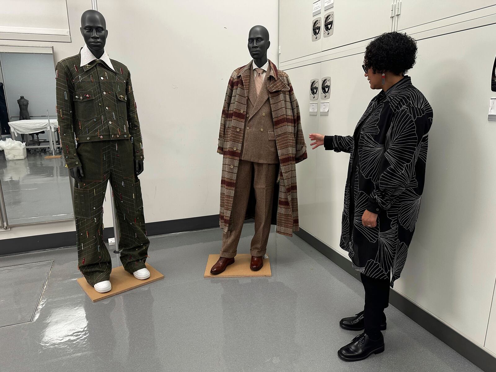 Monica L. Miller, guest curator of the upcoming Costume Institute exhibit “Superfine: Tailoring Black Style," looks over designs in the installation room at the Metropolitan Museum of Art in New York on March 20, 2025. (AP Photo/Jocelyn Noveck)