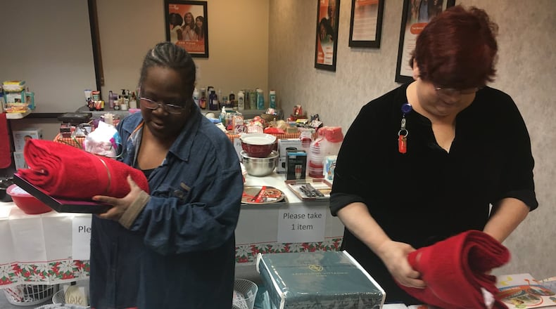 YWCA has seen more than double the in-kind donations this year. Affordable housing residents Myesha Hawkins and Linda Pack shopped at the Holiday market Wednesday. Items at the market are free to residents of both the affordable housing and domestic violence shelter residents who otherwise might not have access to new items around the holidays. STAFF PHOTO / HOLLY SHIVELY