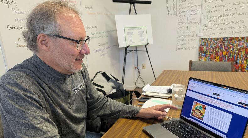 Peter Benkendorf, founder of the Dayton Collaboratory, goes over how people seeking to take part in the Collaboratory's 10-week campaign to wipe out $22 million in medical debt can visit their website at daytoncollaboratory.org/medicaldebt. The 10-week campaign is part of the Collaboratory's Community of Well-Being Initiative, where the group is partnering with the national nonprofit Undue Medical Debt to purchase qualifying medical debt for a fraction of the cost in order to forgiven that debt and relieve the cost burden on people in the Dayton and Springfield regions. SAM WILDOW/STAFF