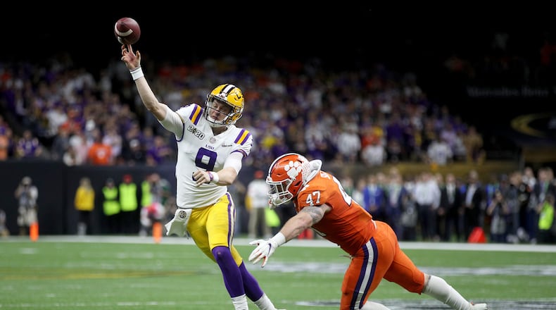 NEW ORLEANS, LOUISIANA - JANUARY 13: Joe Burrow #9 of the LSU Tigers throws the ball under pressure as James Skalski #47 of the Clemson Tigers tries to defend during the College Football Playoff National Championship game at Mercedes Benz Superdome on January 13, 2020 in New Orleans, Louisiana. (Photo by Chris Graythen/Getty Images)