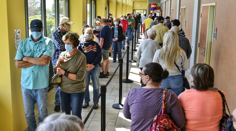 Voters line up at the Butler County Board of Elections on the first day of early voting Tuesday, October 6, 2020 in Hamilton. NICK GRAHAM / STAFF
