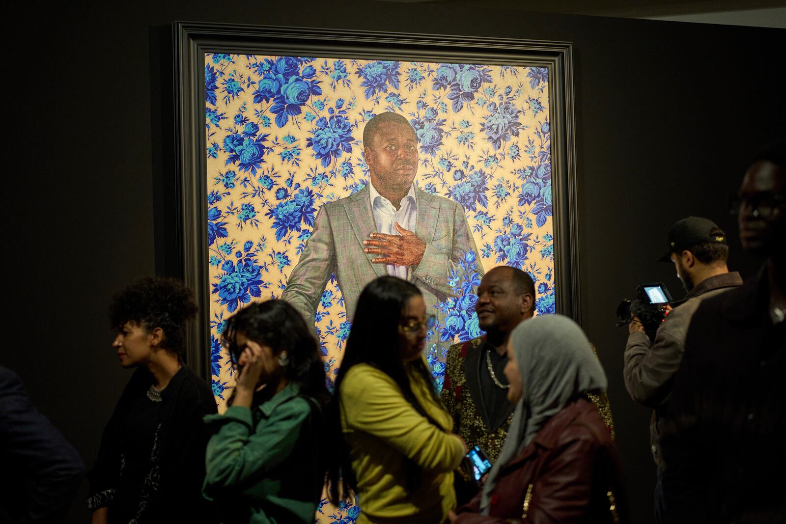 Visitors stand in front of a portrait of Faure Gnassingbé, President of Togo, during the opening of American painter Kehinde Wiley's exhibition A Maze of Power in Mohammed VI Museum of Modern and Contemporary Art, in Rabat, Tuesday, April 15, 2025. (AP Photo/Mosa'ab Elshamy)