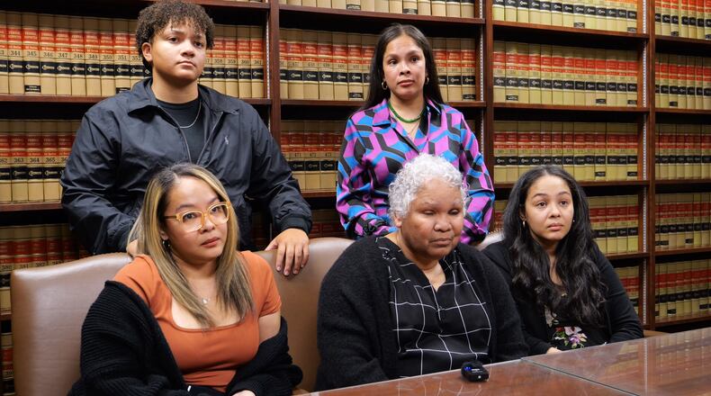 Family members of slain Dayton Police Detective Jorge DelRio, in a video and photograph provided Monday by Dayton police. From left: Seated is Veronica DelRio. Standing behind her is Naya DelRio. At the center is Kathy DelRio. Seated on Kathy's left is Erica Hampton. And standing behind Kathy is Ariel Bush.