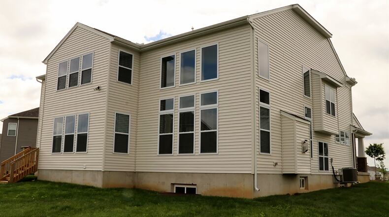 A 2-story great room has walls of windows that also add natural light to the upstairs loft family room. The basement has been finished to include a media room, a recreation room with wet bar, a full bathroom and a bedroom with an egress window.