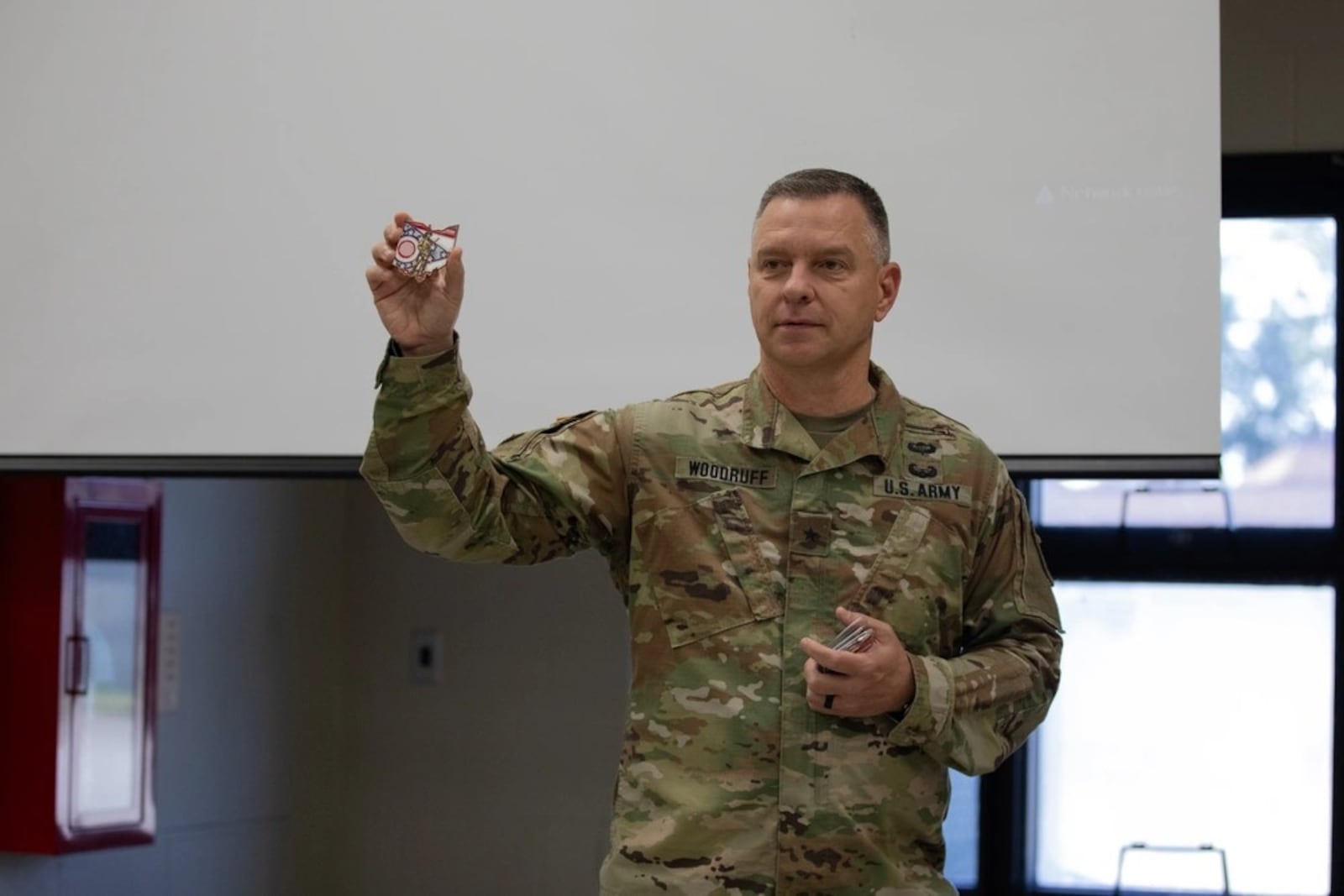 Brig. Gen. Matthew S. Woodruff, then Ohio assistant adjutant general for Army, presents his challenge coin during the 2024 Ohio National Guard Joint Judge Advocate Legal Workshop at Camp Perry Joint Training Center, in Port Clinton, Ohio, Aug. 10, 2024. (Army National Guard photo).