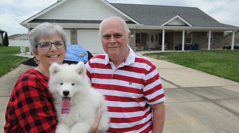 The Lynch family, from left, Charlotte, Trixie and Jim at their home in Beavercreek, which was rebuilt after the 2019 tornadoes. MARSHALL GORBY\STAFF
