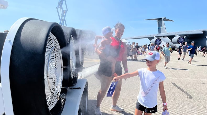 Show-goers at the CenterPoint Energy Dayton Air Show revel in the cooling mist at a water station Saturday, June 21, 2025. THOMAS GNAU/STAFF
