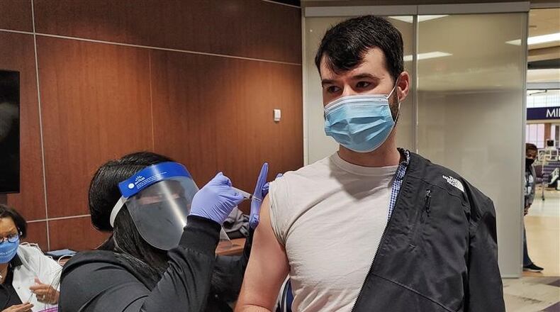Teachers and school staffers at Middletown Schools lined up Wednesday morning, Jan. 27, 2021, to be the first school employees in Ohio to get a coronavirus injection. About 500 Middletown school employees were scheduled to come to Middletown High School Wednesday to receive the first of two planned injections to immunize them from the coronavirus. (PHOTO BY NICK GRAHAM\JOURNAL-NEWS)