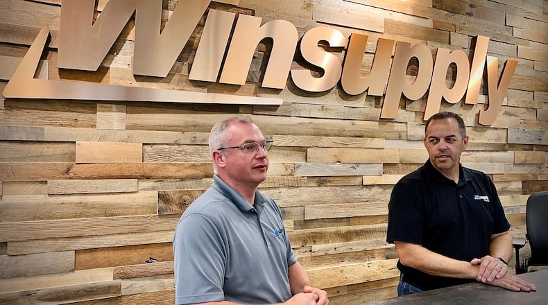 Bill Tolliver, Winsupply Inc.'s vice president of real estate services (left) and Jeff Williams, president of Winsupply of Dayton, talk about Winsupply's new Richard W. Schwartz Center for Innovation in Moraine. MARSHALL GORBY/STAFF