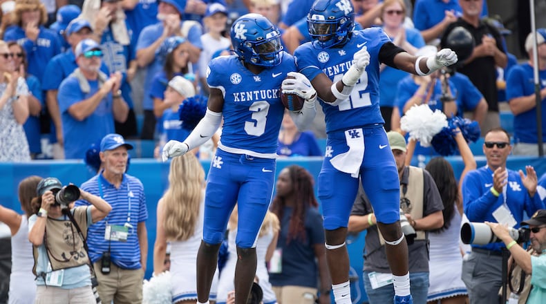 Kentucky defensive back Alex Afari Jr. (3) and linebacker Tyreese Fearbry (42) celebrate after an interception late in the second half of an NCAA college football game against Florida in Lexington, Ky., Saturday, Sept. 30, 2023. (AP Photo/Michelle Haas Hutchins)