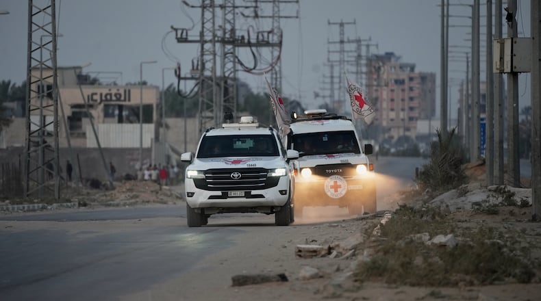 Red Cross vehicles carrying the bodies of two people believed to be deceased hostages handed over by Hamas make their way toward the Kissufim border crossing with Israel, to be transferred to Israeli authorities, in Deir al-Balah, central Gaza Strip, Thursday, Oct. 30, 2025. (AP Photo/Abdel Kareem Hana)