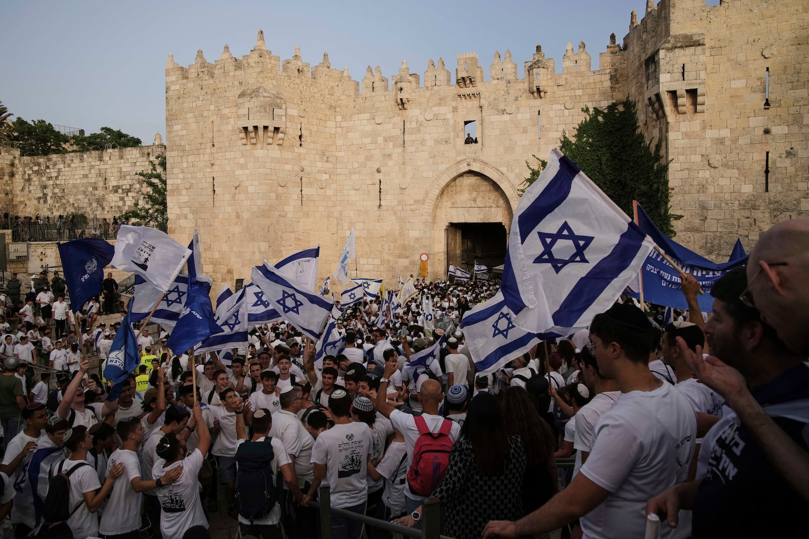 Israelis participate in a march marking Jerusalem Day, an Israeli holiday celebrating the capture of east Jerusalem in the 1967 Mideast war, in Damascus Gate of Jerusalem's Old City, Monday, May 26, 2025. (AP Photo/Leo Correa)