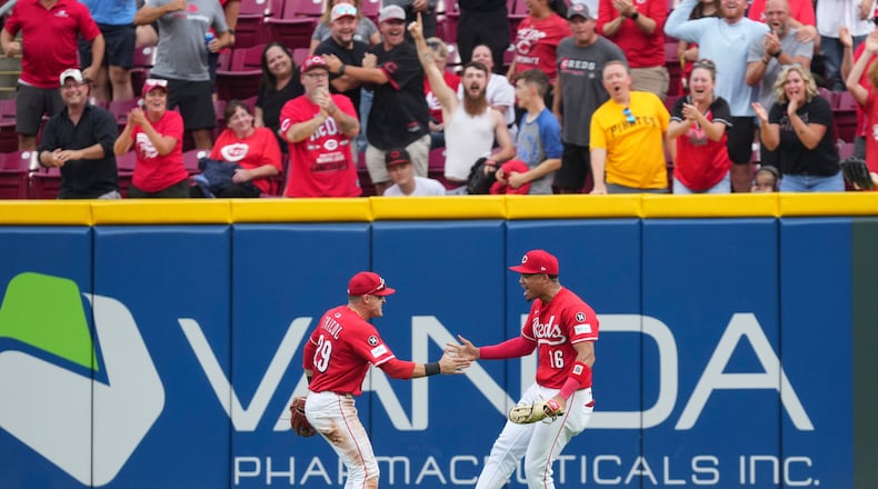 Cincinnati Reds outfielder Noelvi Marte (16) celebrates with teammate TJ Friedl (29) after catching a fly ball hit by Pittsburgh Pirates' Bryan Reynolds during the ninth inning of a baseball game, Thursday, Sept. 25, 2025, in Cincinnati. (AP Photo/Jeff Dean)