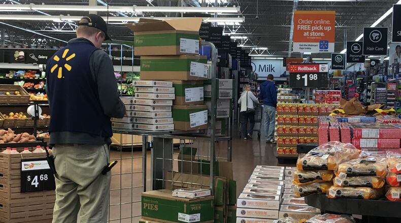 A Walmart worker unloads pumpkin pies onto a display the week before Thanksgiving last year. Walmart is once again the biggest employer in Ohio, according to the Ohio Development Services Agency. KARA DRISCOLL/STAFF