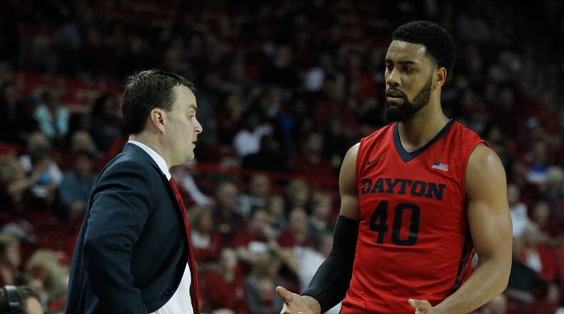 Dayton forward Devon Scott, right, and coach Archie Miller talk during a game against Arkansas on Saturday, Dec. 13, 2014, at Bud Walton Arena in Fayetteville, Ark. David Jablonski/Staff