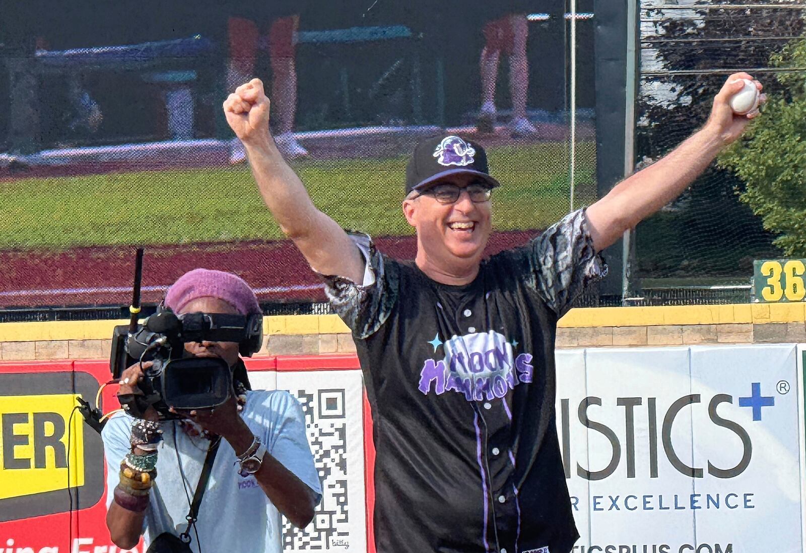 John Oliver prepares to throw the first pitch during a game between the Chesapeake Oyster Catchers and the Erie Moon Mammoths at UMPC Park in Erie, Pa., on Saturday, July 19, 2025. (AP Photo/Joe Reedy)