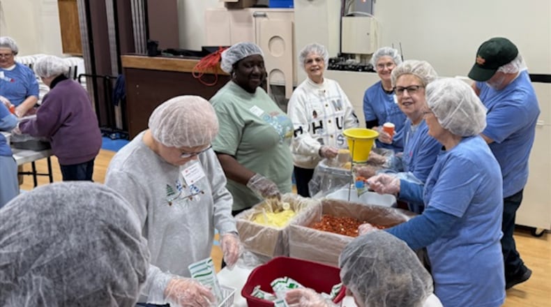 Volunteers met Jan. 17 at Abiding Christ Lutheran Church in Fairborn to pack 35,640 meals for the people of Ukraine. Each bag contained dehydrated vegetables, vitamins, soy, and rice which makes six meals per bag. Nine churches from all around the Dayton area were represented in an effort to feed the hungry. CONTRIBUTED