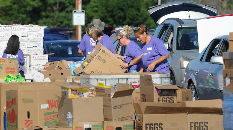 FILE PHOTO: The Dayton Foodbank, Inc. along with nearly 200 volunteers from CareSource served over 1,000 families at the University of Dayton Arena Mass food distribution Tuesday Aug. 23, 2022. MARSHALL GORBY\STAFF