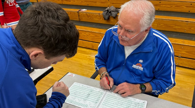 Miamisburg High School boys basketball scorekeeper tallies the scorebook after the Vikings game against Kings on Feb. 17, 2026. Anslinger has kept the book for the boys basketball program for more than 55 years. TOM ARCHDEACON / CONTRIBUTED PHOTO